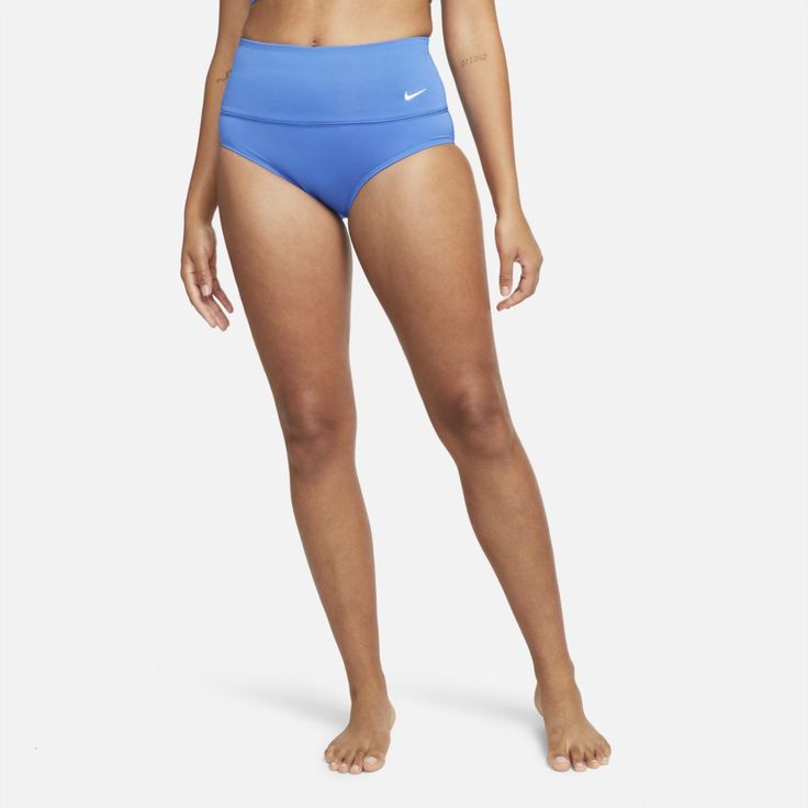 COMFORT. COVERAGE. FLATTERING FIT. Get a little extra coverage and a flattering look with the Nike Essential Swim Bottoms. Their wide stretch waistband gives you a comfortable fit that stays in place, while a zippered back pocket offers secure storage. Benefits Moderate back and bottom coverage provides comfort and lets you move freely. Fully lined design offers a better fit and support. Product Details Heat-transferred Swoosh design 83% polyester/17% elastane Hand wash Imported Style: NESSA215; Blue High Waist Swimwear With Elastic Waistband, Blue High-waisted Shorts For Swimming, Blue Workout Bottoms With Contoured Waistband, Nike Stretch Blue Bottoms, High Waist Athleisure Bottoms For Beach, Nike Blue Stretch Bottoms, Sporty Blue Bottoms With Contoured Waistband, Nike Swimwear With Built-in Shorts For Swimming, Blue High Waist Sporty Swimwear