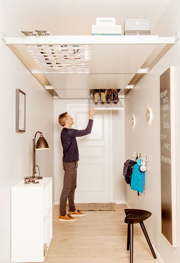 a young boy is reaching up to the ceiling