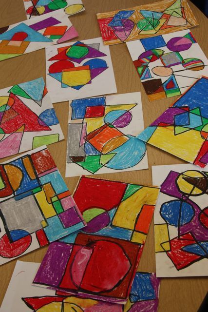 several pieces of art are laid out on a table with crayons and pencils