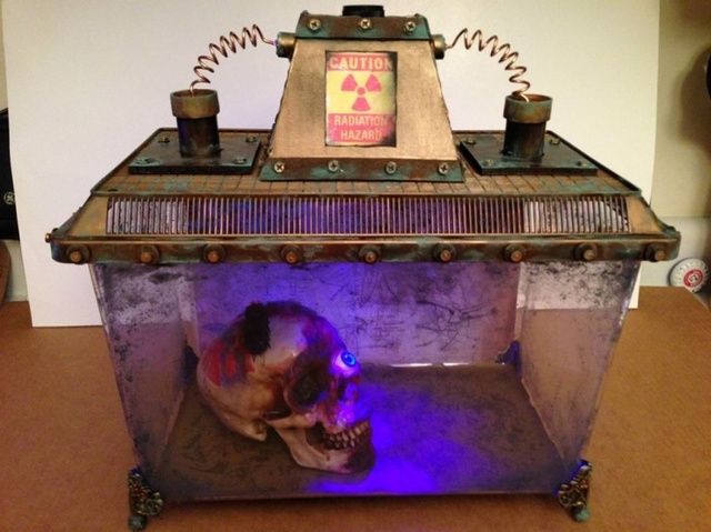 an old fashioned clock with a skull in it's center and purple light on the front