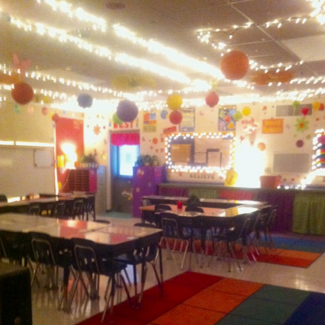 an empty classroom is decorated with lights and decorations