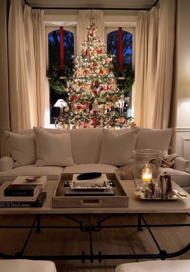 a living room filled with furniture and a christmas tree