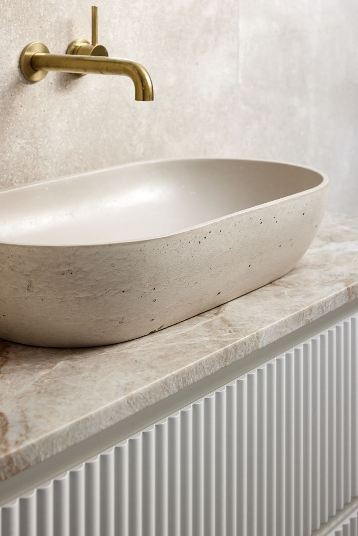 a white bowl sink sitting on top of a counter