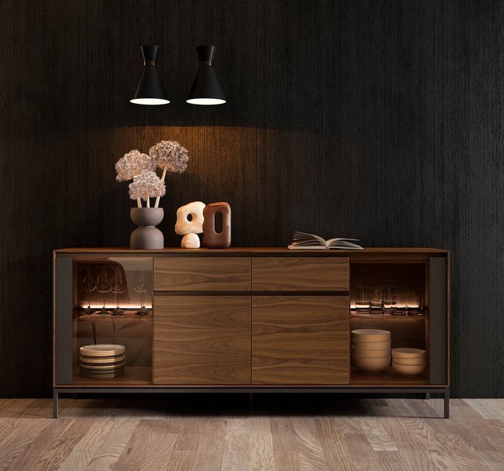 a wooden cabinet with two lights above it and vases on the top shelf next to it