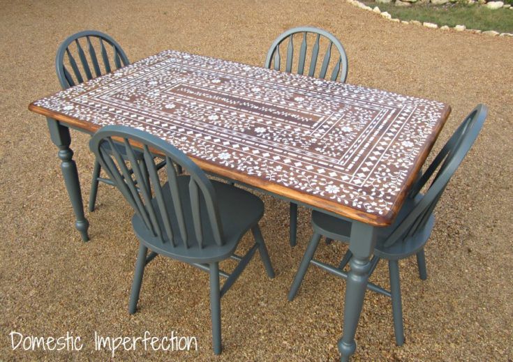 a table and four chairs sitting in the gravel