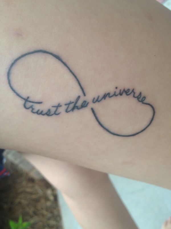 a woman's arm with a tattoo that says trust the universe on it and an infinite knot