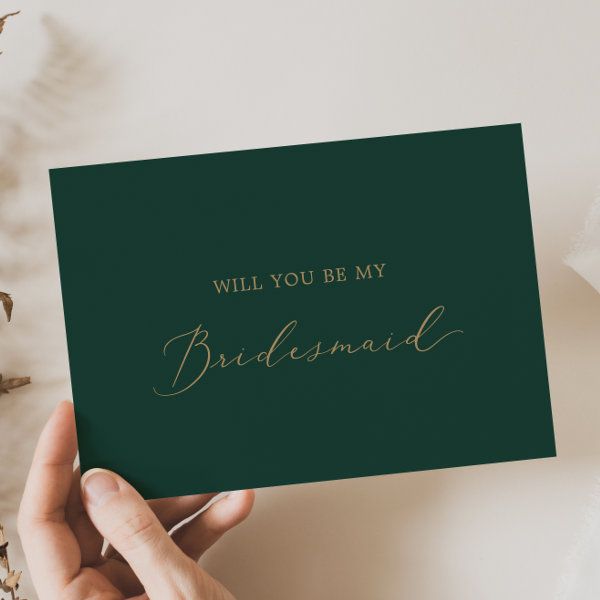 someone holding up a card that says, will you be my bridesmaid?