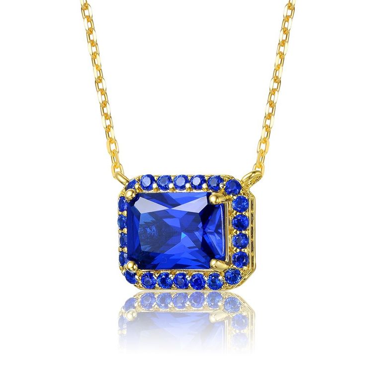 14k Yellow Gold Plated with Radiant Cut Blue Sapphire Cubic Zirconia Solitaire Halo Petite Pendant Necklace. Add vibrancy to your day or night wardrobe with this stunning 14k yellow gold plated necklace. A rectangular/radiant cut blue sapphirecubic zirconias (September Birthstone). A shiny cable chain connected on each side of this glamorous pendant allows it to sit centered when worn, gracing the collarbone and securing by a lobster clasp. Gold Birthstone Jewelry With Lab-created Sapphire, Gold Jewelry With Lab-created Sapphire Birthstone, Fine Jewelry Gold Ring With Lab-created Sapphire, Gold Jewelry With Lab-created Sapphire For Anniversary, Blue Clavicle Chain Jewelry For Formal Occasions, Formal Blue Clavicle Chain Jewelry, Royal Blue Cubic Zirconia Jewelry Gift, Brass Pendant Necklace, September Birthstone