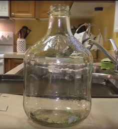 a large glass bottle sitting on top of a kitchen counter