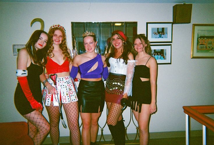 four women dressed up in costumes posing for the camera