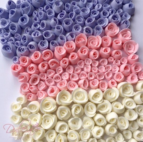 several different colors of flowers are arranged in the shape of an american flag with white, pink, and blue petals