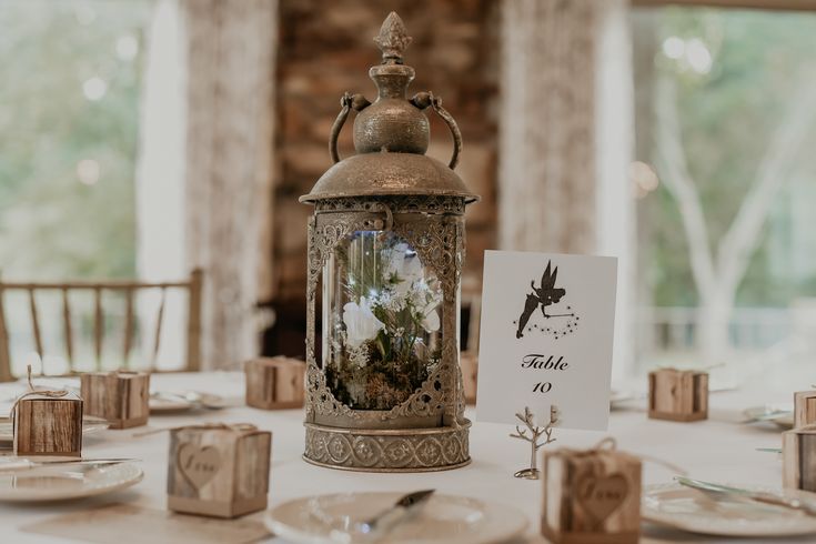 a table set up with place cards and candles