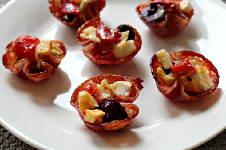 small appetizers are arranged on a white plate