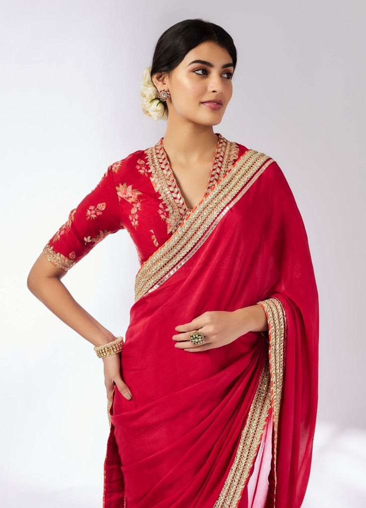 This classic chiffon sari, adorned with delicate gold embroidery, gracefully highlights the intricate patterns, adding an air of elegance. Paired with a beautifully printed blouse featuring elbow sleeves, the ensemble exudes opulence and grandeur, reminiscent of timeless royalty. Perfect for making a stunning impression at any special occasion. Traditional Formal Saree With Intricate Embroidery, Traditional Saree With Intricate Embroidery For Formal Occasions, Elegant Red Traditional Wear, Elegant Red Art Silk Blouse Piece, Elegant Red Dupatta In Traditional Drape, Elegant Red Pre-draped Saree For Festive Occasions, Formal Saree With Intricate Embroidery For Eid, Red Georgette Blouse Piece For Eid, Elegant Red Dupatta Traditional Drape