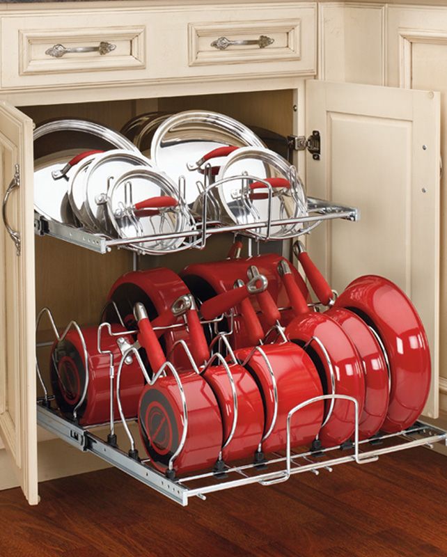 the kitchen space saver is open to show red pots and pans