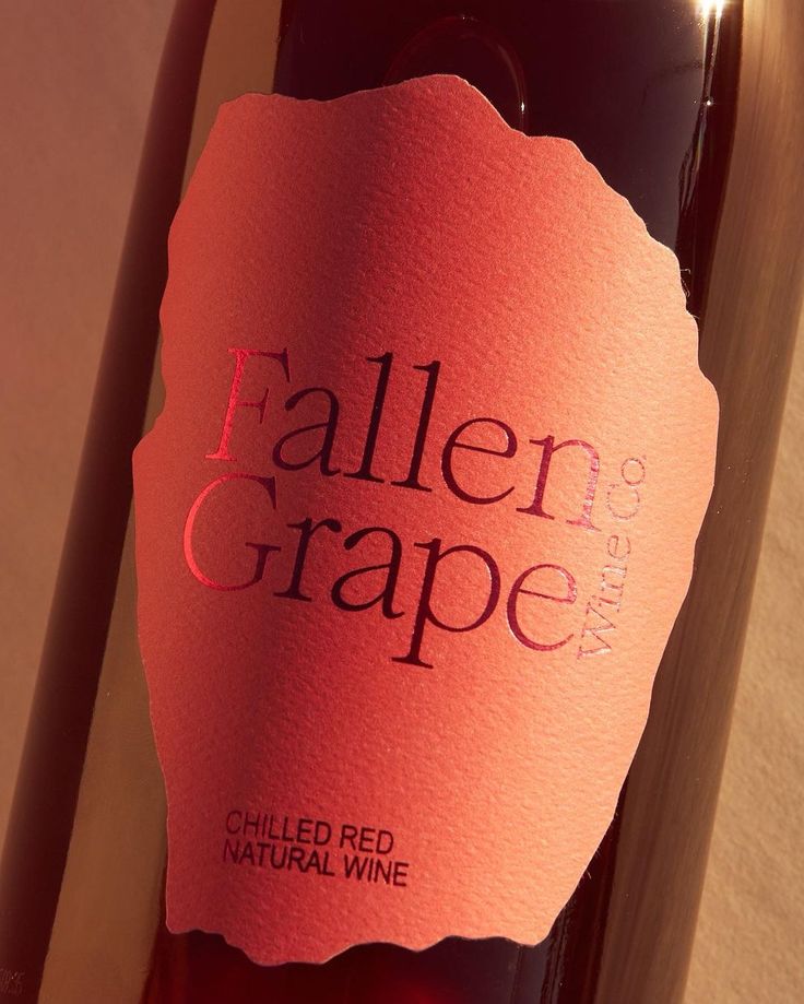 a bottle of red wine with a label on it that says, fallen grape cellar