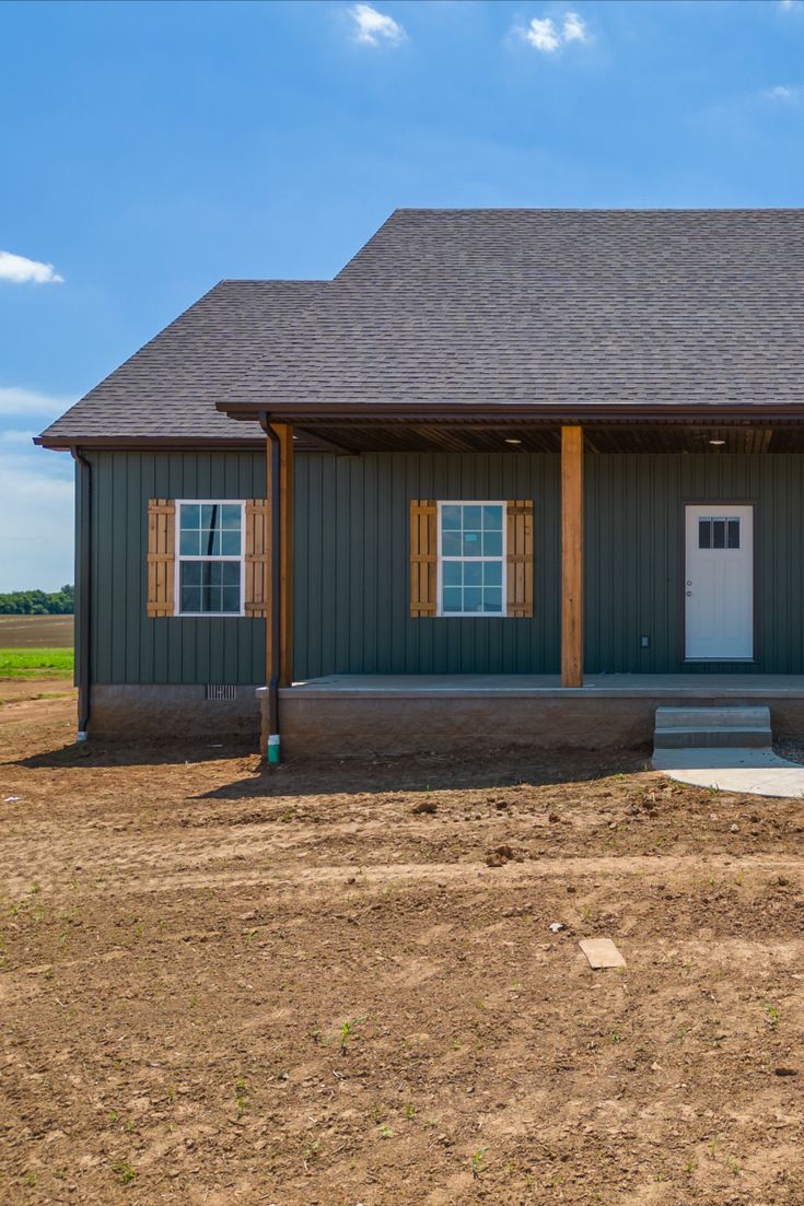 the front of a two story house with an attached porch and covered entryway to it