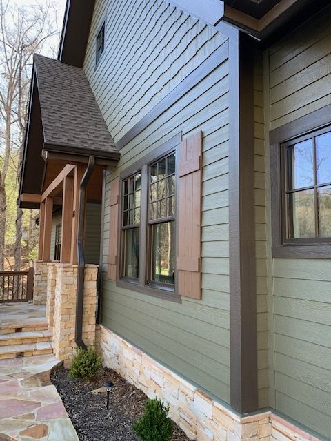 a house that has some windows on the side of it and steps leading up to it