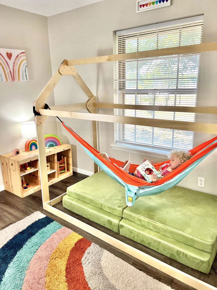 a child's bed with a hammock attached to the top and bottom