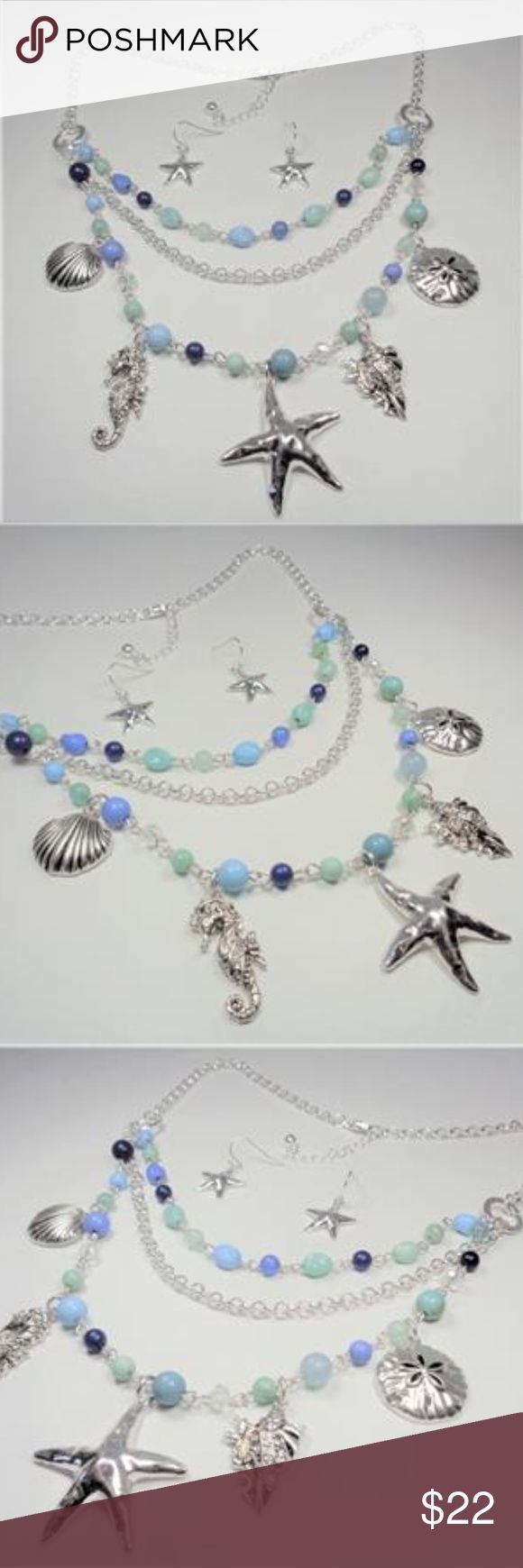 NAUTICAL AQUA & BLUE SEA LIFE NECKLACE & EARRINGS This beautiful Rhodium Nautical Starfish Seashell Aqua And Blue Beads Sea Life layered necklace and earrings set features aqua, blue and rhodium beads with the rhodium sea horse, seashells, sand dollar and starfish charms as well as aqua and blue beads and bluish pearls. The silver tone necklace is 20 inches long with a 2 inch extender to 22 inches and has a lobster claw clasp for a secure fit on your neck. The starfish pendant measures 1 1/2 inc Adjustable Blue Jewelry With Starfish Charm, Bohemian Blue Starfish Charm Jewelry, Bohemian Blue Jewelry With Starfish Charm, Ocean-inspired Beaded Jewelry, Blue Multi-strand Jewelry With Dangling Beads, Blue Necklaces With Starfish Charm And Round Beads, Blue Metal Jewelry For Beach, Ocean-inspired Colorful Beads Jewelry, Turquoise Dangle Earrings With Ocean-inspired Style