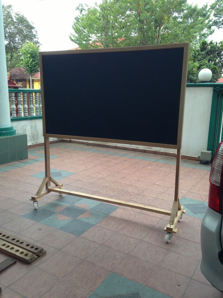 a large black board is in the middle of a patio