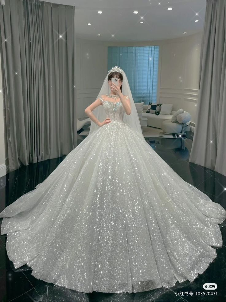 a woman in a white wedding dress is taking a selfie with her cell phone