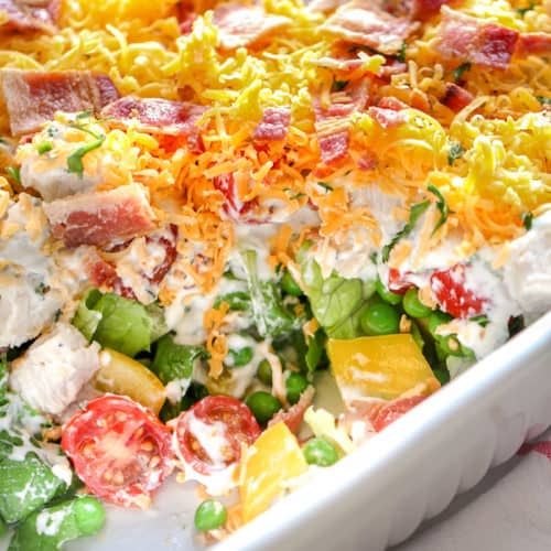 a large casserole dish filled with lots of different types of vegetables and cheese