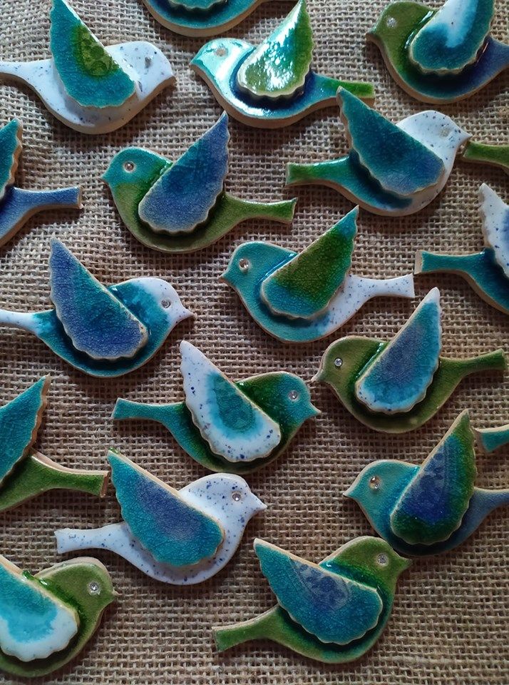 decorated cookies with blue and green birds on a table