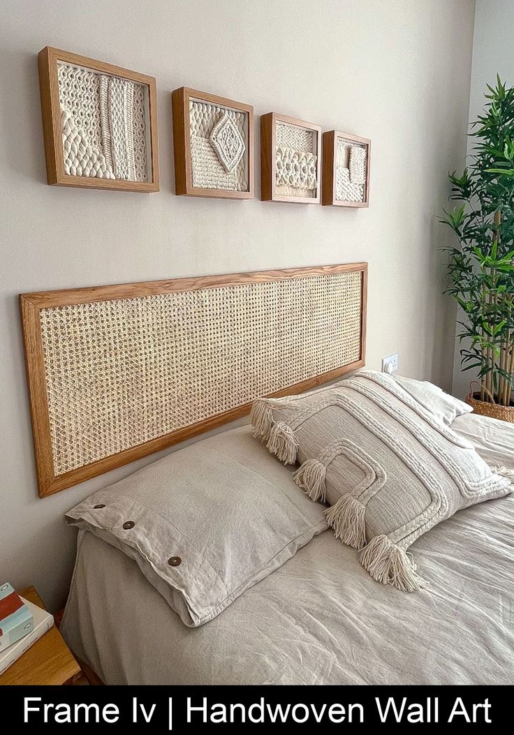 a bed with white linens and pillows in a bedroom next to a potted plant