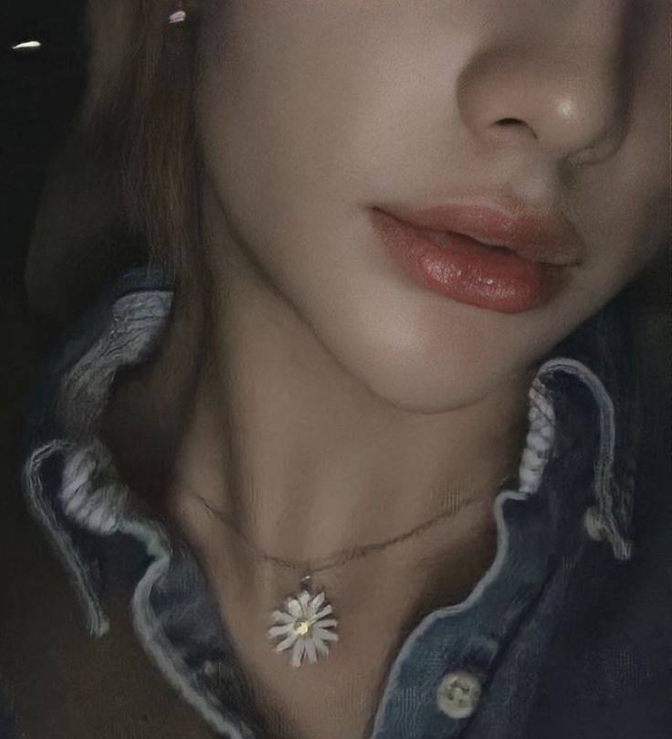 a close up of a woman's face wearing a denim shirt and flower necklace