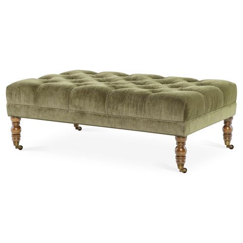 a bench with wooden legs and a green velvet upholstered cushion on the back