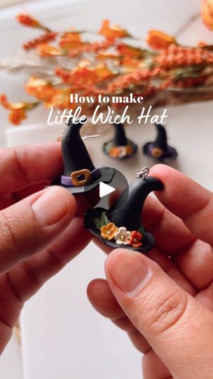 someone is making little witch hats out of tiny fake flowers and other things that are on the table