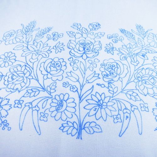 a blue drawing of flowers on a white shirt