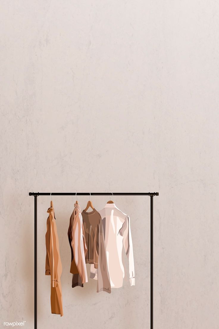 three shirts hanging on a clothes rack in front of a white wall with an iron frame