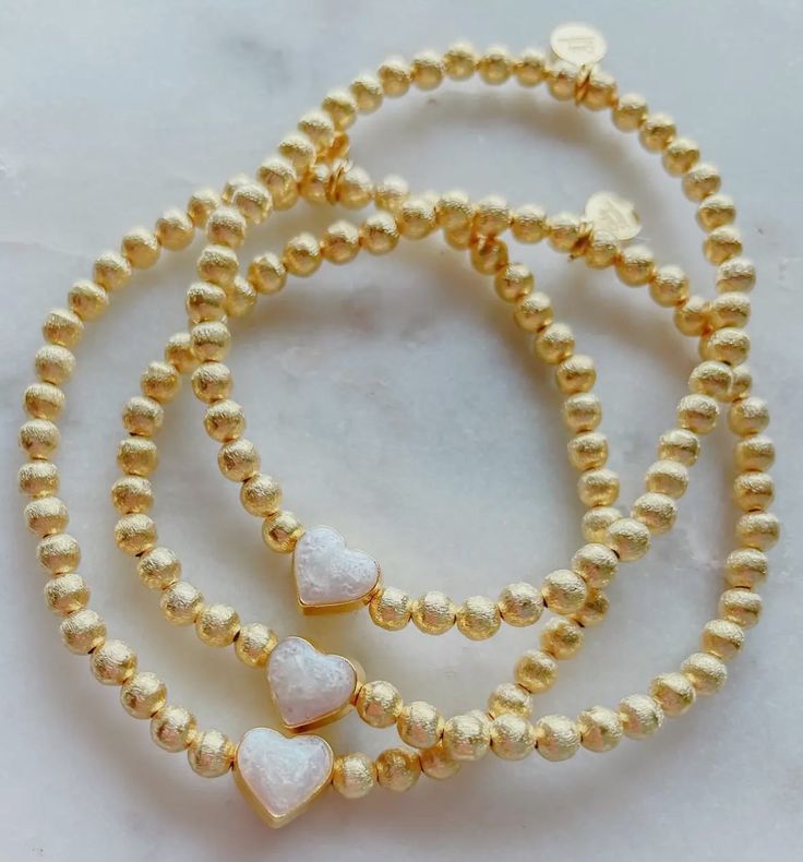 Create the perfect stack or start a collection for someone special. 8mm gold plated beaded bracelet 7-inch elastic stretch band Permeant Jewelry, Elegant Gold Stretch Bracelet With Heart Beads, Gold Stackable Heart Bracelet For Valentine's Day, Gold Heart-shaped Pearl Bracelet With Heart Beads, Gold Heart-shaped Beaded Stretch Bracelet, Gold Stretch Bracelet With 14k Gold-filled Beads, Bracelet Pearl, Stretch Band, Stretch Bands