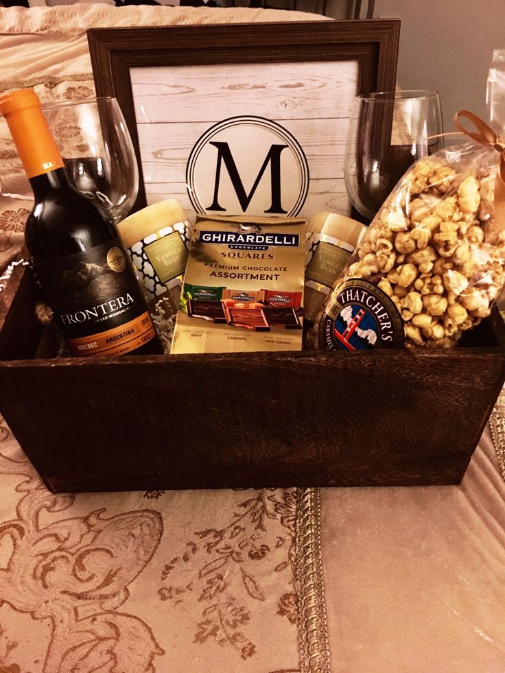 a wooden box filled with wine and snacks