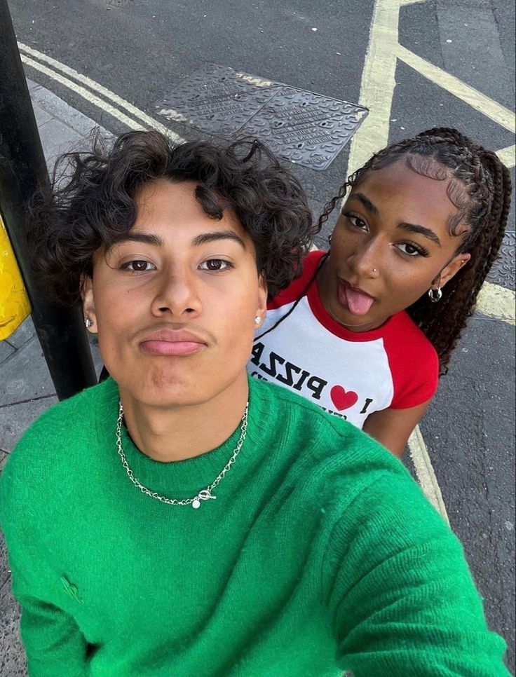 two women standing next to each other on the street