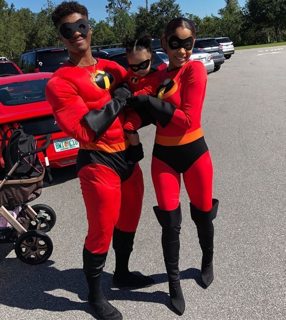 two women in red and black costumes are standing next to each other with their arms around one another