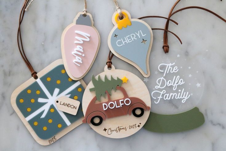 four christmas ornament hanging on a marble surface