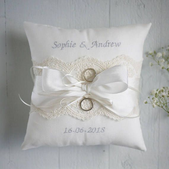 a ring pillow with two wedding rings on it