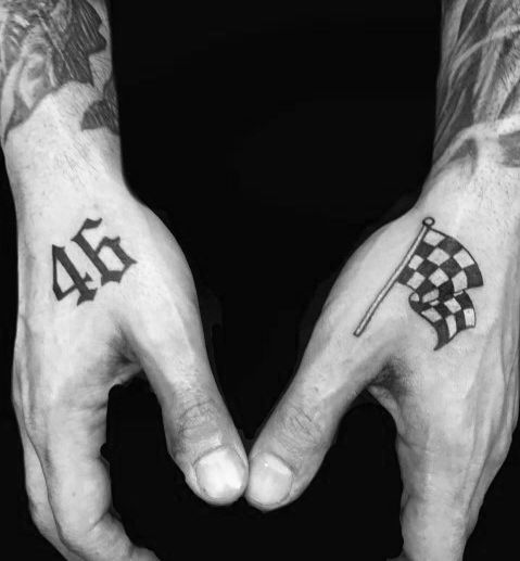 two hands holding each other with tattoos on their fingers and the numbers forty, forty and forty