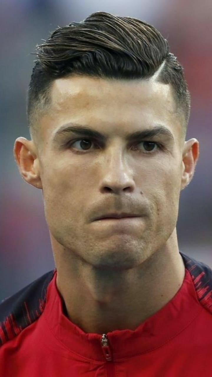 a close up of a soccer player wearing a red shirt