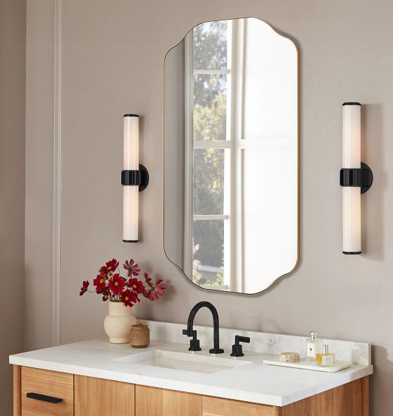 a bathroom vanity with two sinks and a large mirror