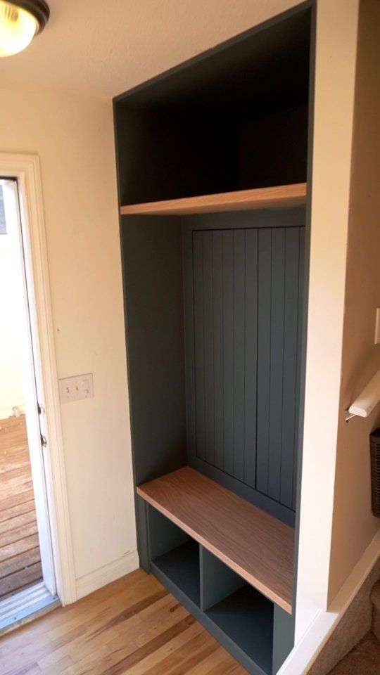 an empty room with wooden floors and a built - in bookcase on the wall