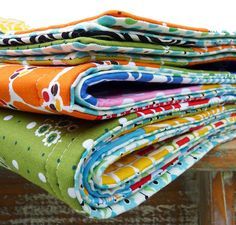 several different colored fabrics stacked on top of each other