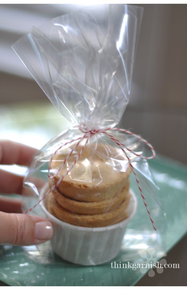 a hand holding a plastic bag filled with cookies