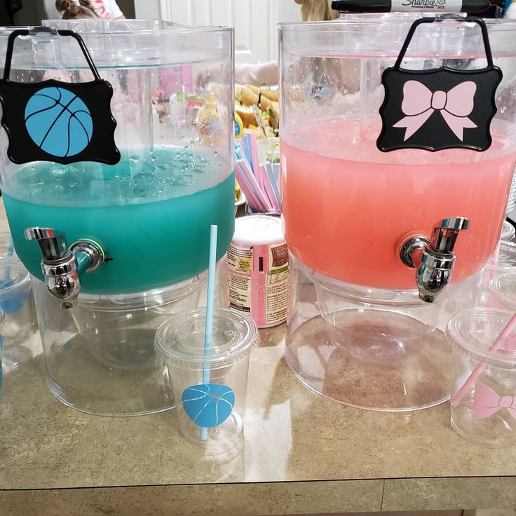 three different colored drinks sitting next to each other on top of a counter with straws