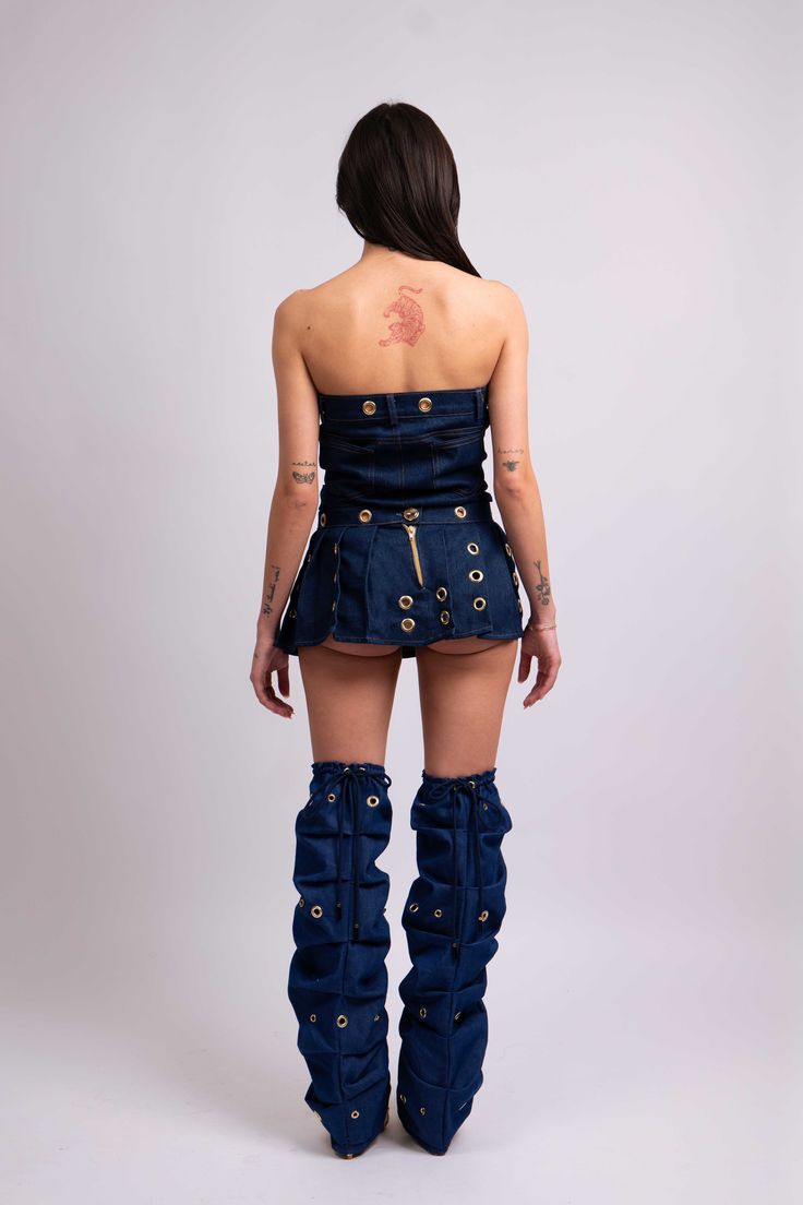 Destiny Denim Top Key Features: Dark blue denim Brass grommets Deconstructed design Zipper bustier Details: The Destiny Denim Top is crafted from dark blue denim, featuring a deconstructed design that reimagines a classic skirt into a chic bustier top. Brass grommets add a punk-inspired touch, while the zipper closure ensures a secure fit. Content + Care: 98% Cotton, 2% Spandex. Machine wash cold, tumble dry low. Size + Fit: Model is 5'4" and wears a size small. Our Notes: For a bold look, pair Edgy Denim Skirt Outfit, Pleated Denim Mini Skirt, Leather And Denim, Pleated Denim, Denim Skirt Outfits, Earthy Outfits, Classic Skirts, Punk Inspiration, Dark Blue Denim