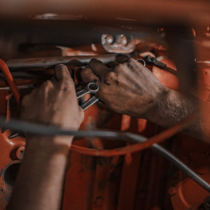 a man working on an engine in a car