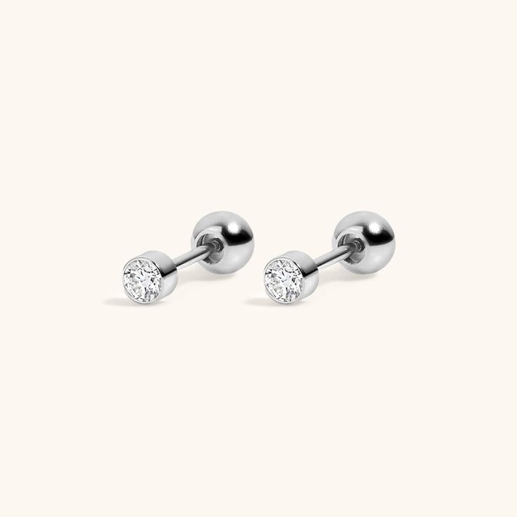 The ultimate anchor for your ear stack, our signature Tiny Crystal Studs are now available in implant grade titanium for 24/7 waterproof, sweatproof, lifeproof wear. Also available as a titanium flat back for cartilage piercings. For a solid gold alternative, check out the Tiny Sapphire Studs or the Tiny Diamond Studs. SPECS & SIZING Solid implant grade titanium with high quality CZ Gold version is coated in 18k gold PVD Plating 3mm in diameter 20G post, 6mm wearable surface, 10mm total length S Classic Silver Internally Threaded Piercings, Classic White Gold Internally Threaded Cartilage Earrings, Classic Internally Threaded Huggie Piercings, Classic Huggie Internally Threaded Piercings, Classic White Gold Huggie Piercings, Adjustable Tarnish Resistant Piercings For Everyday, Adjustable Hypoallergenic White Gold Piercings, Hypoallergenic Adjustable White Gold Piercings, Hypoallergenic White Gold Huggie Piercings